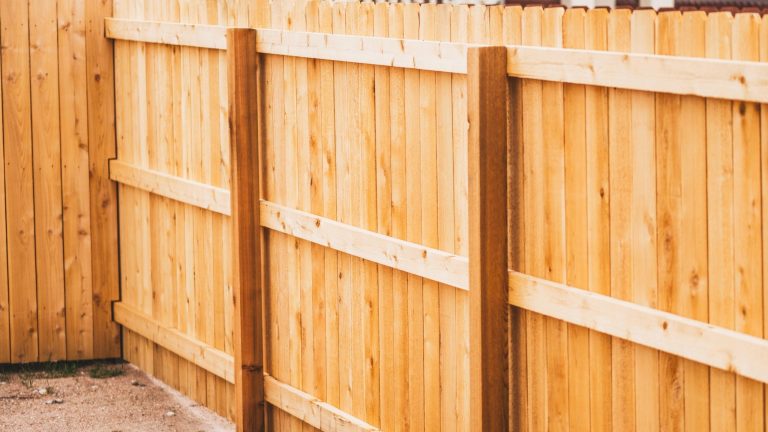 Custom driveway gate installed with a fence in Montgomery County