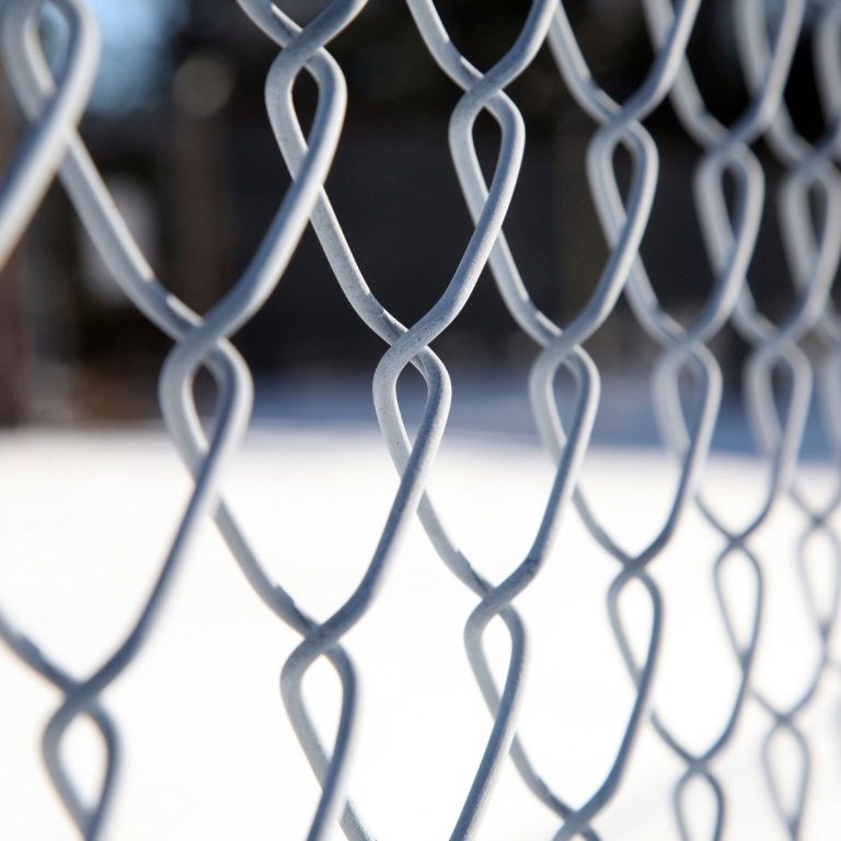 Close view of heavy gauge chain link mesh on a commercial fence