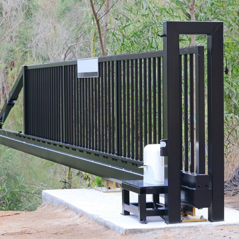 Sliding gate drive motor and track at a driveway entrance