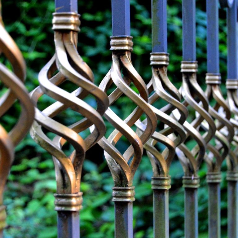 Decorative metal balusters with a twisted basket detail on an ornamental gate